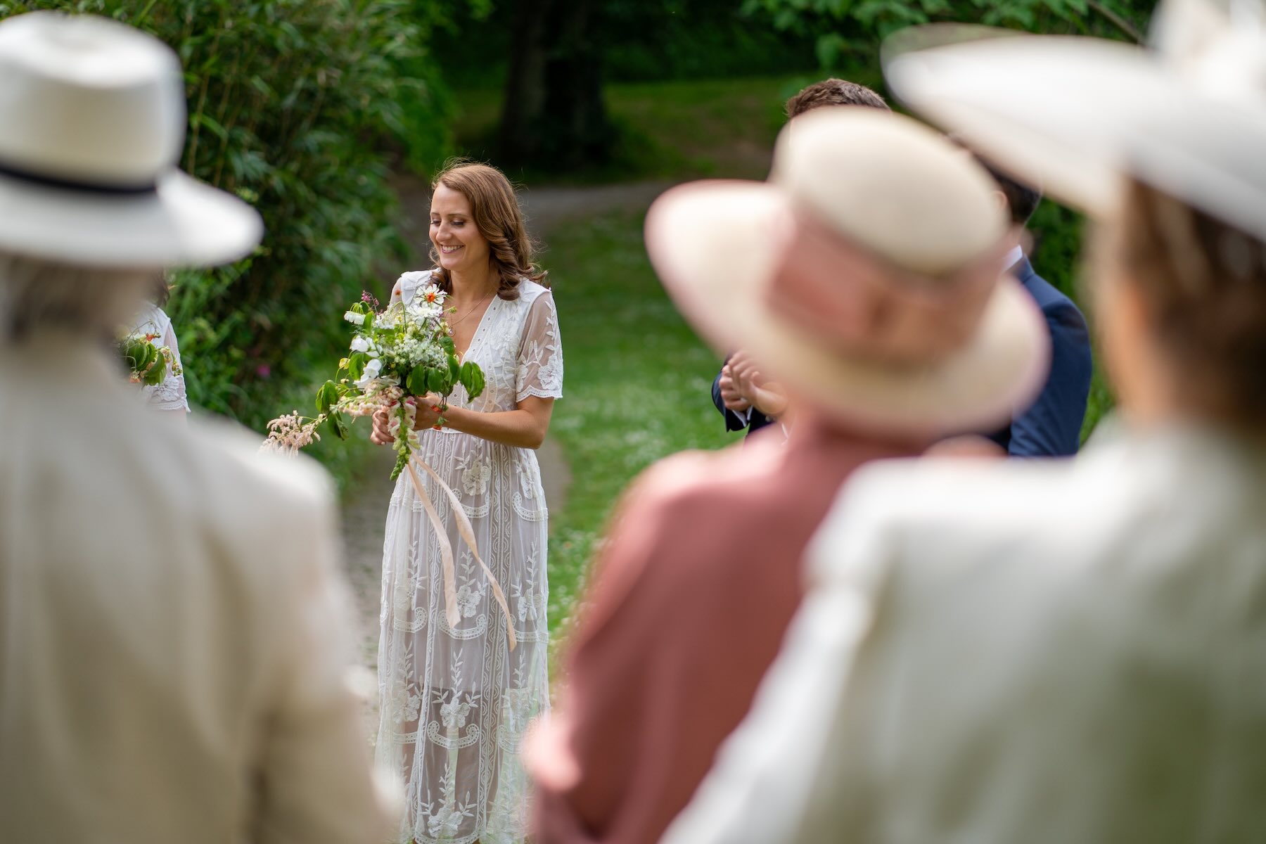 Head bridesmaids sharing a candid moment captured through hybrid photo film wedding coverage.
