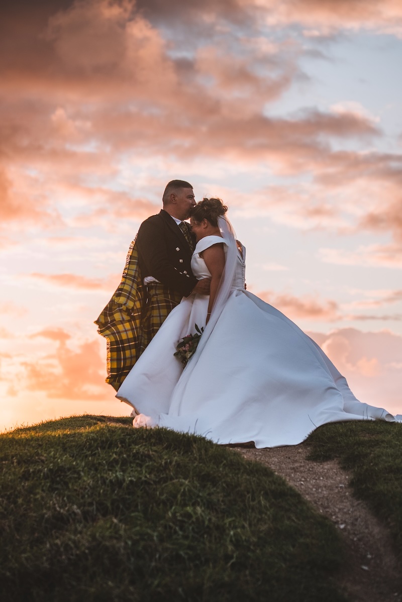 Cornwall wedding videographer portrait session with a couple at sunset on the Newquay coast