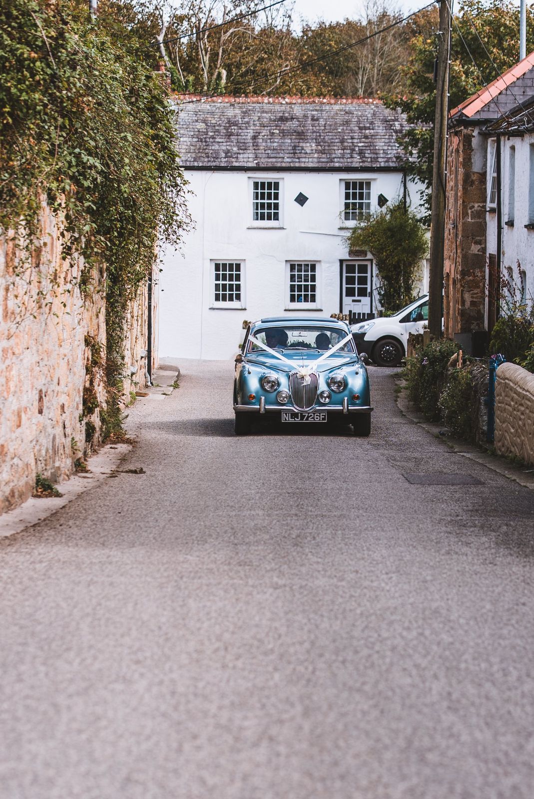 Classic blue wedding car arriving at St Columb Minor, Cornwall