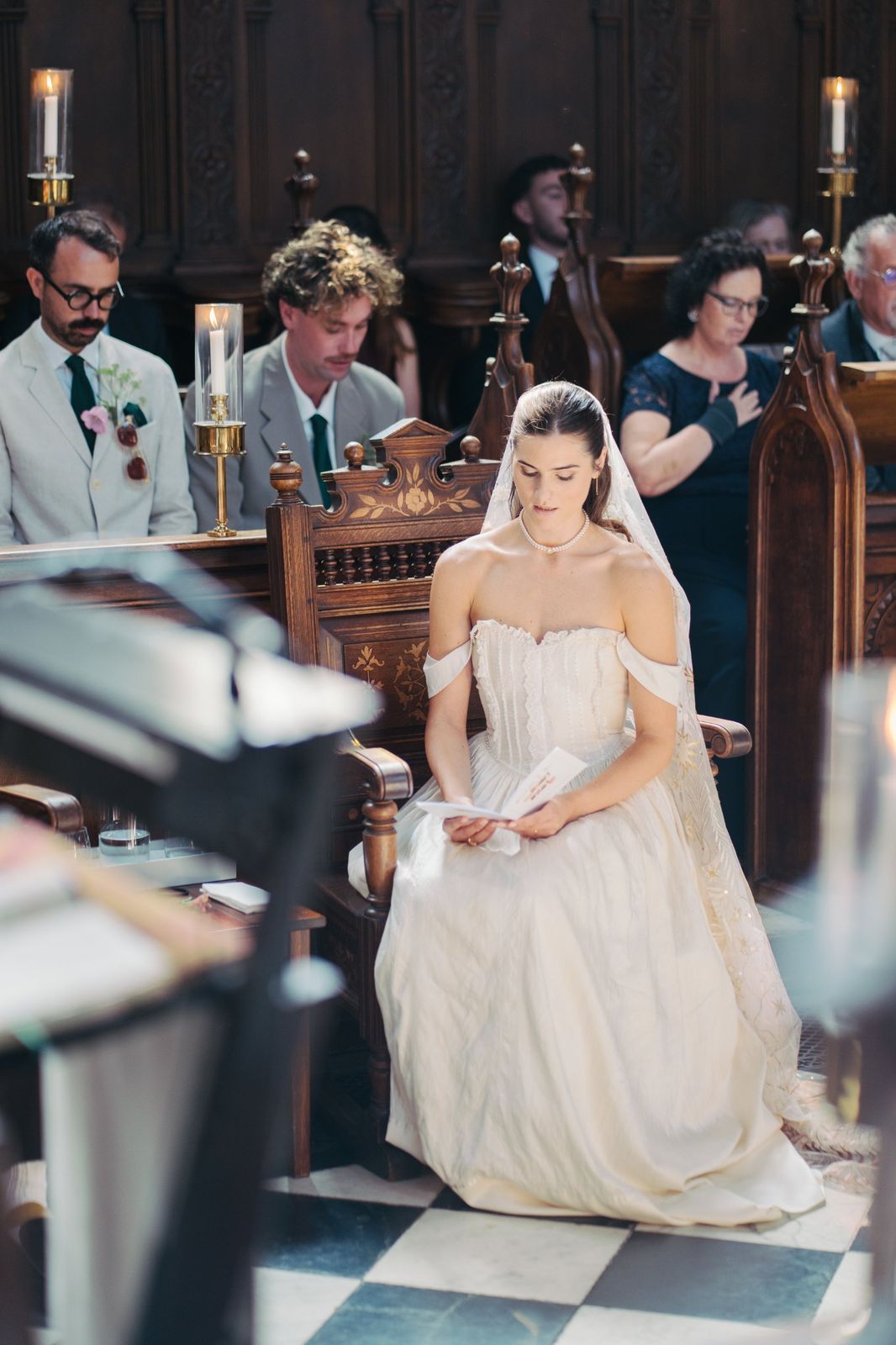 Bride seated during the ceremony in Wadham College chapel