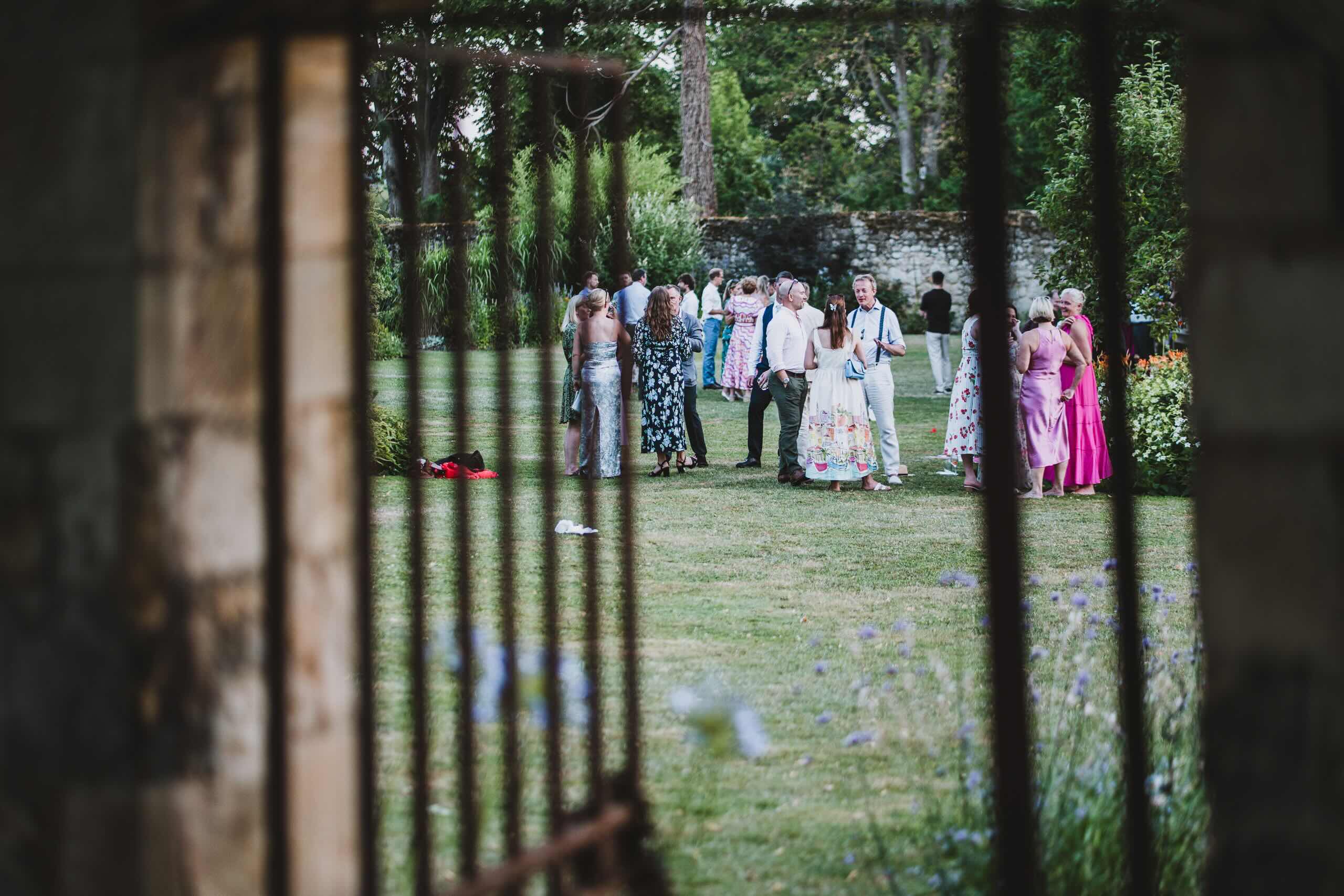 Wedding guests talking together during an outdoor garden reception