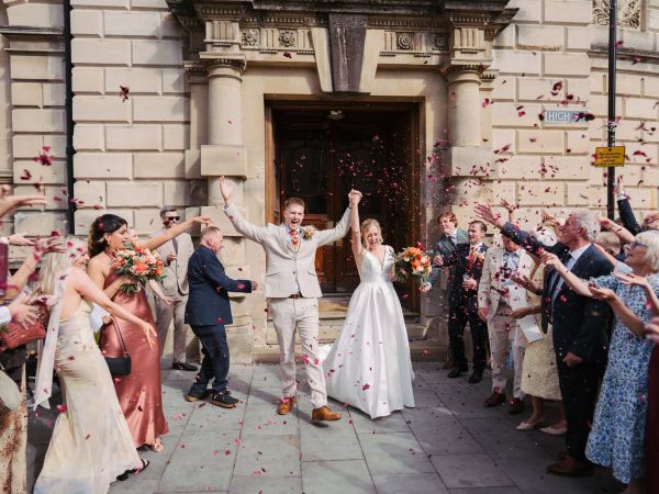 Couple leaving Bath Register Office under confetti, Somerset wedding